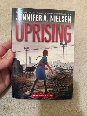 Scholastic Uprising Paperback with Blue Dress and Red Title